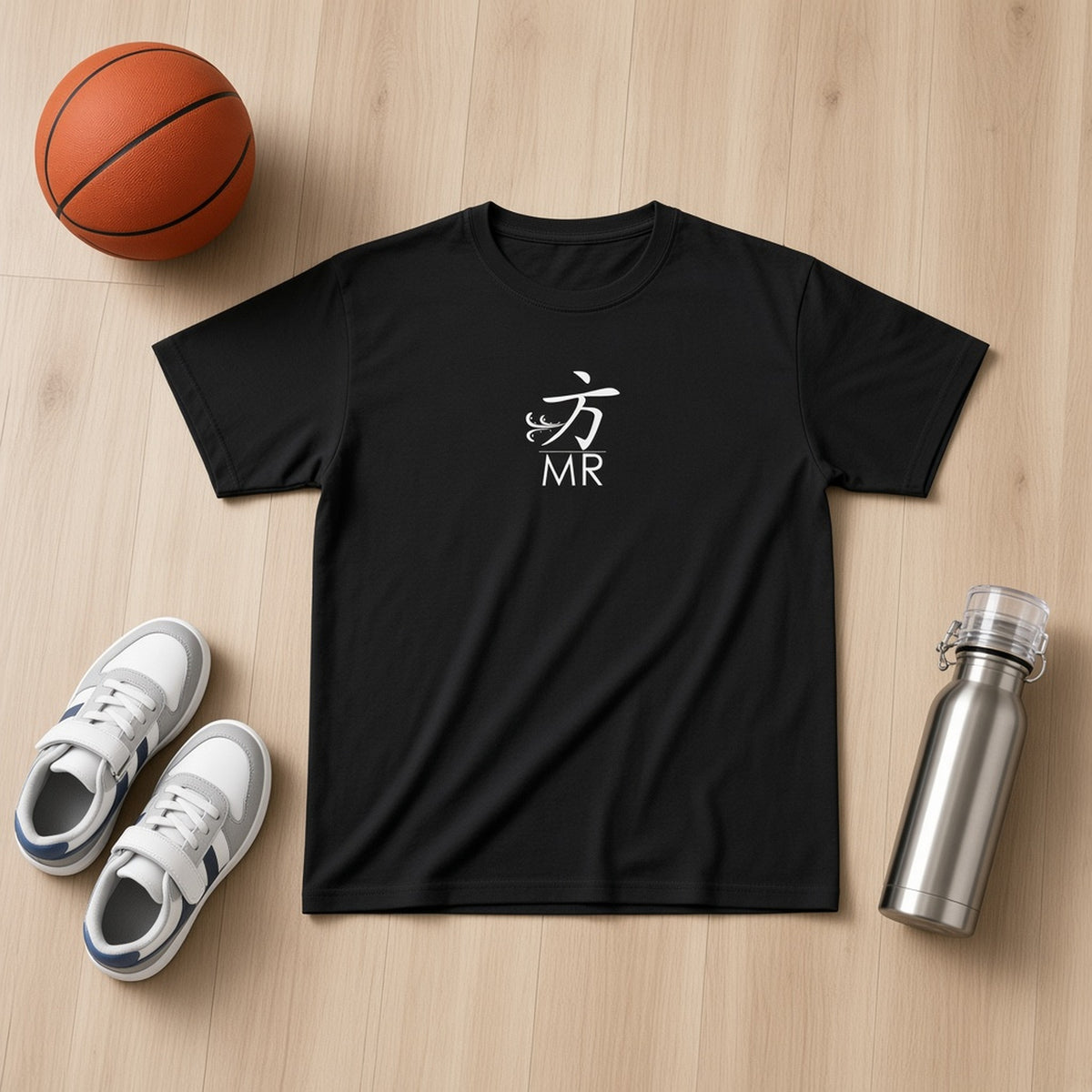Flat lay of a 1 Moore Rep black youth tee with white 方 MR logo beside sneakers, a basketball and a bottle