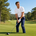 Golfer addressing the ball on a fairway in a 1 Moore Rep white men's embroidered golf polo and navy pants