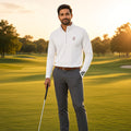 Man on a golf course at sunset in a 1 Moore Rep white men's embroidered golf quarter-zip with a club